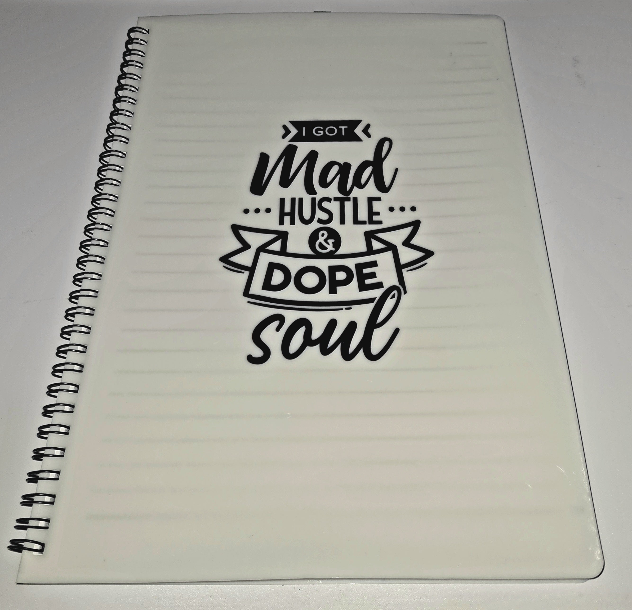 Notebook with motivational quote on a white background