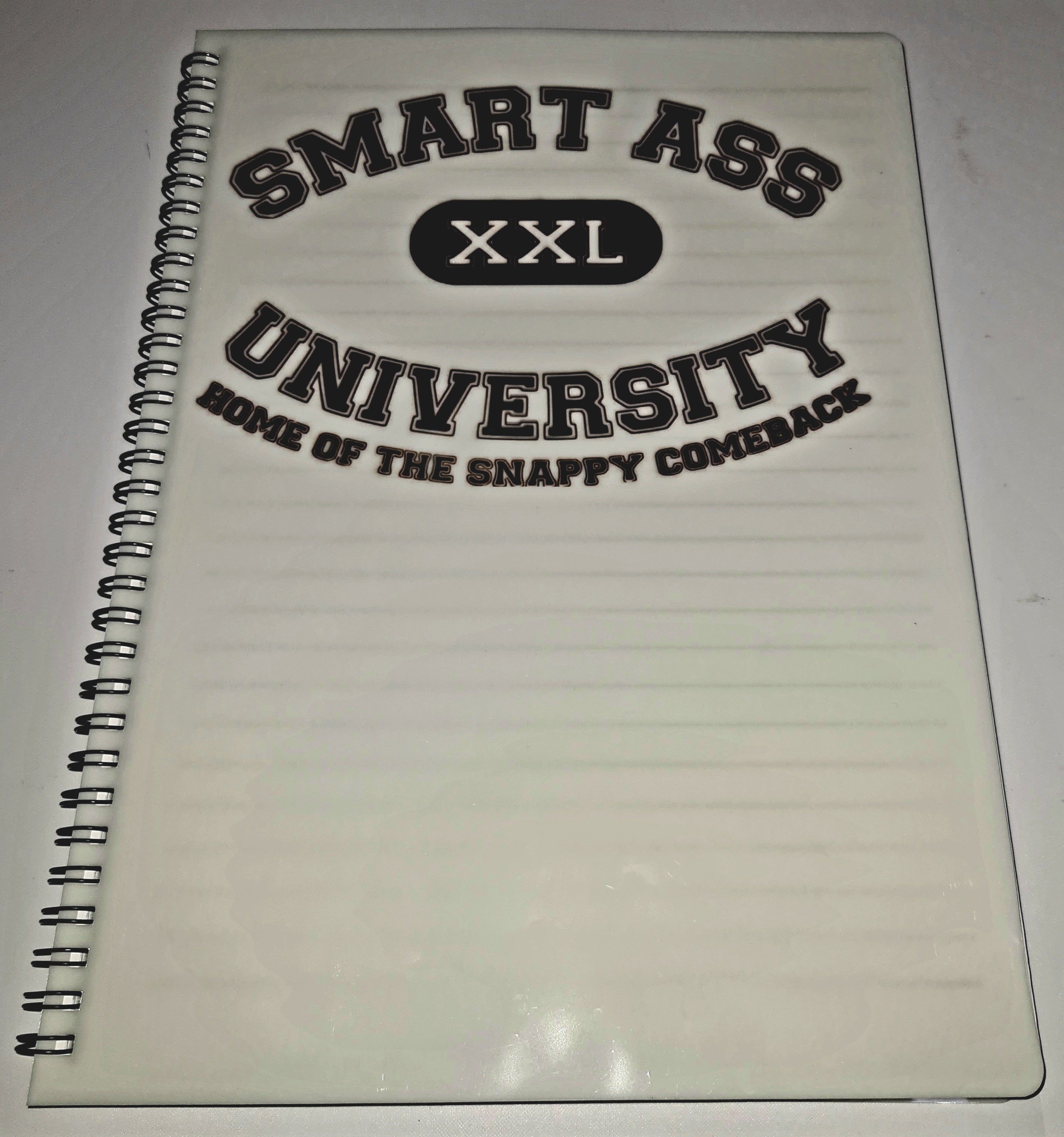 Notebook with 'Smart Ass University' text on a white background